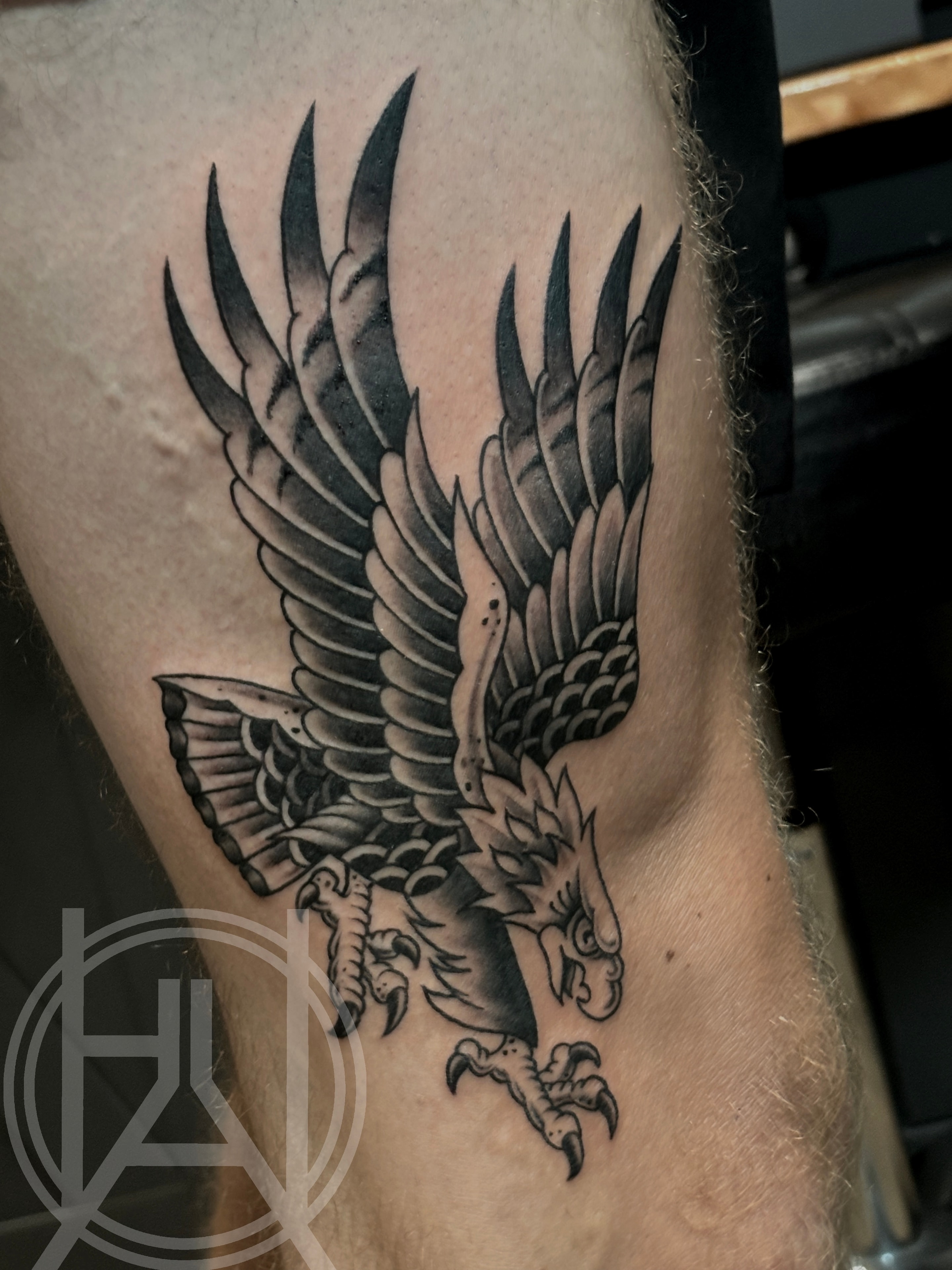 Traditional diving eagle with spread wings — black and grey
