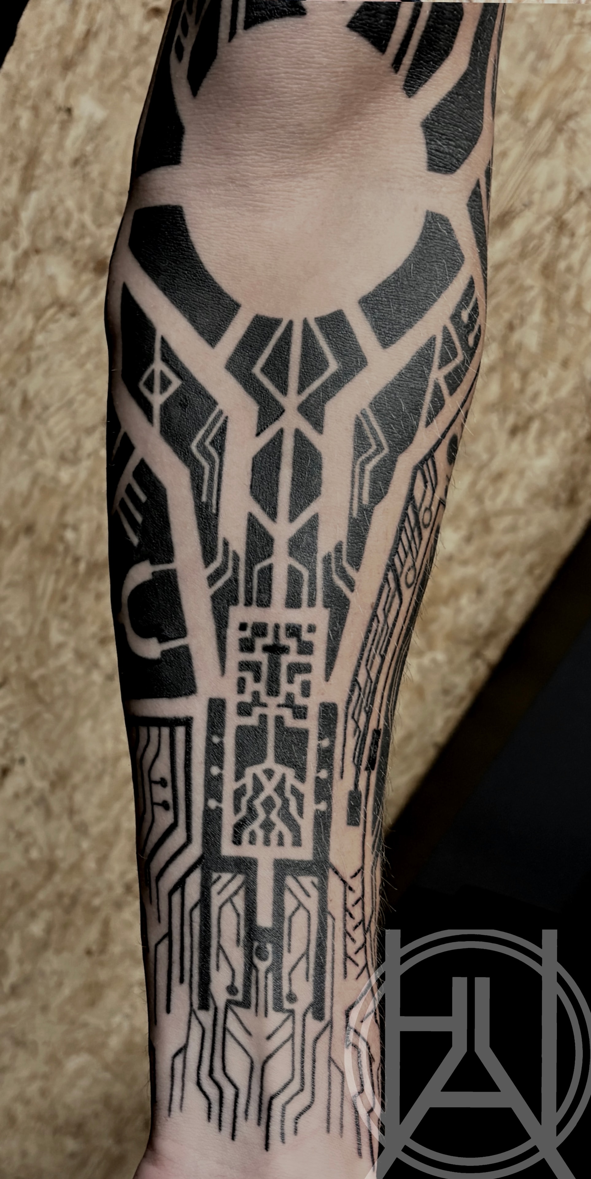 Geometric circuit board forearm detail — blackwork