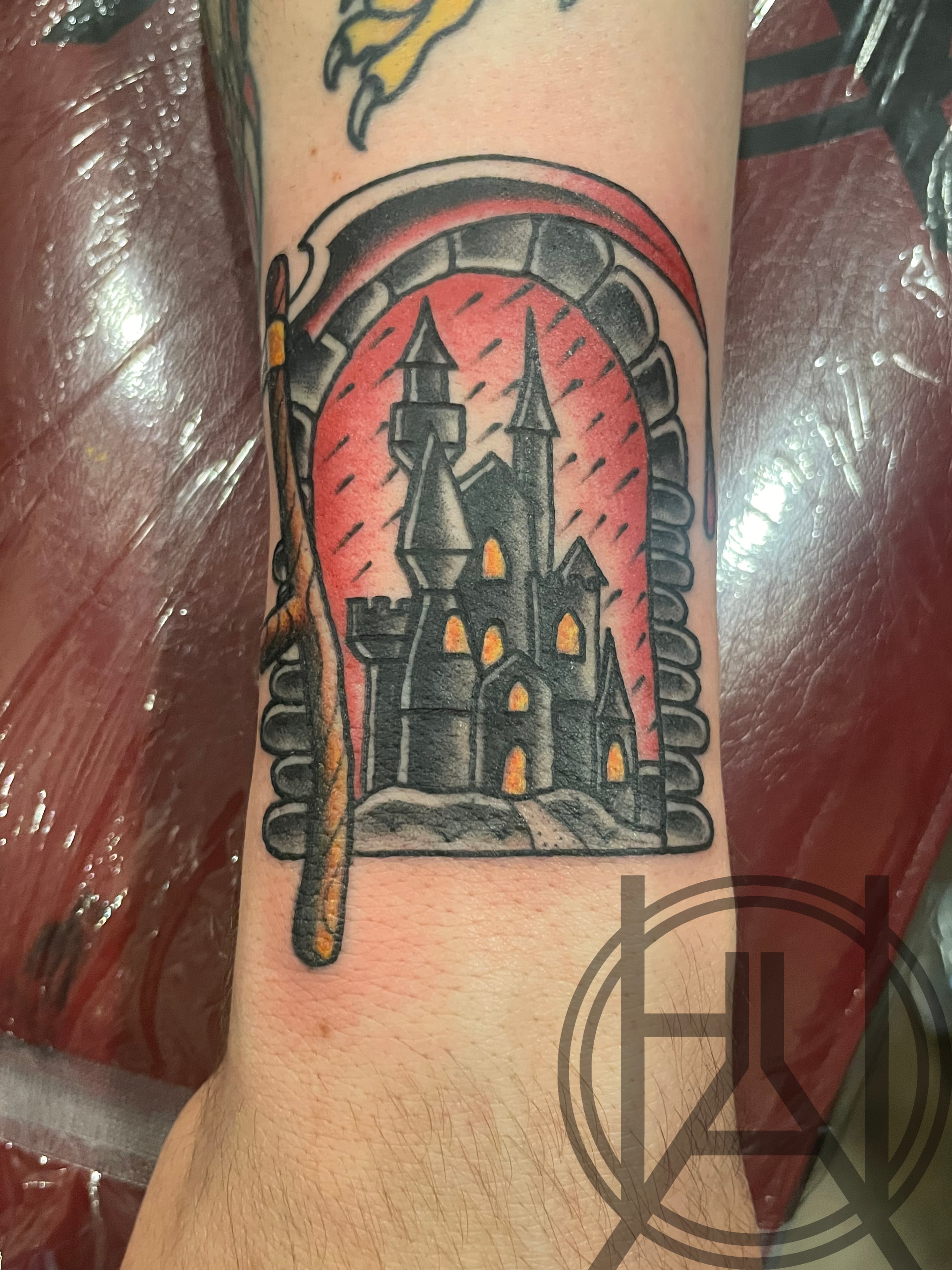 Hogwarts castle with broomstick in stone arch — color wrist