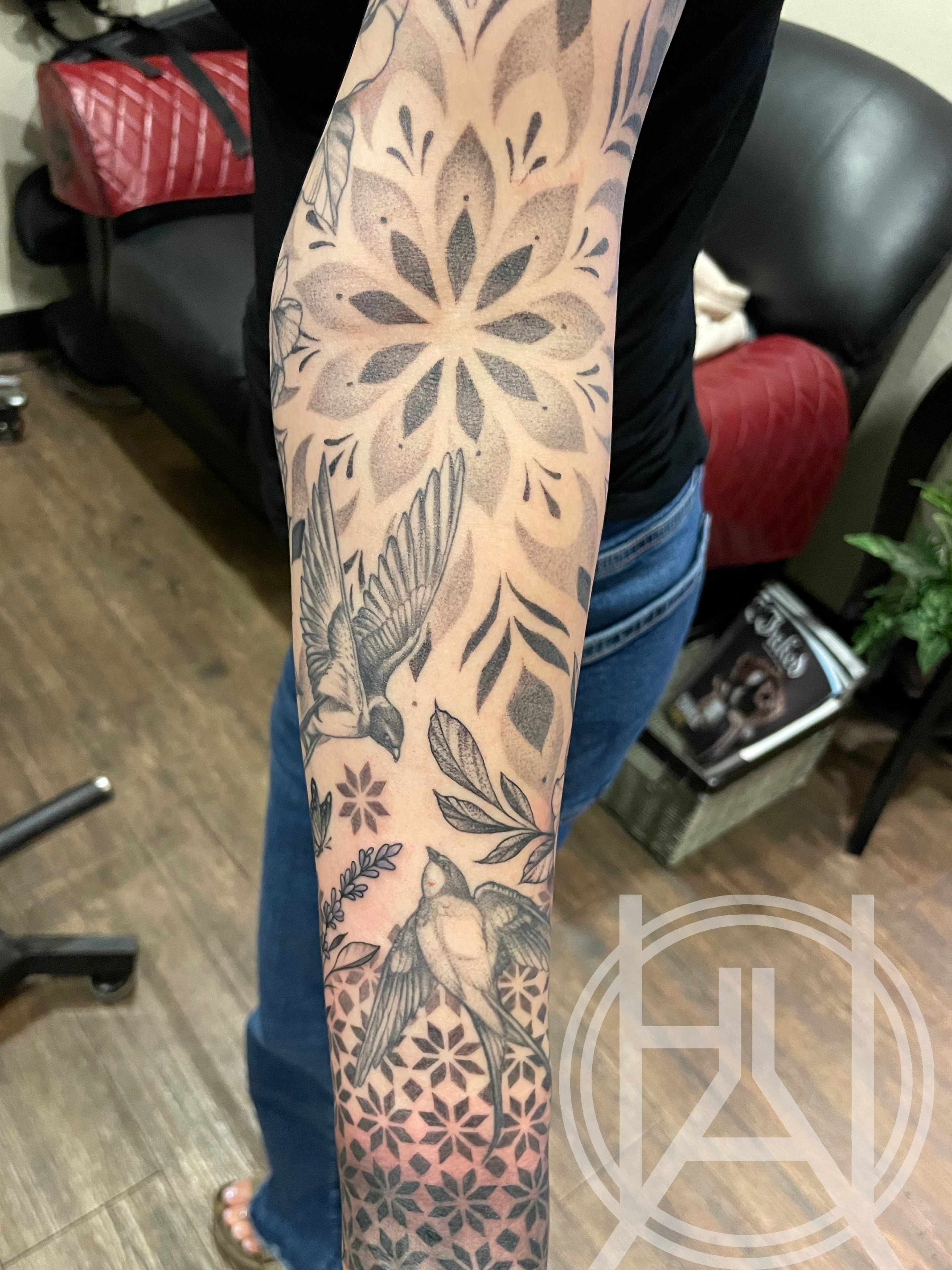 Mandala, swallows, and geometric pattern dot work sleeve
