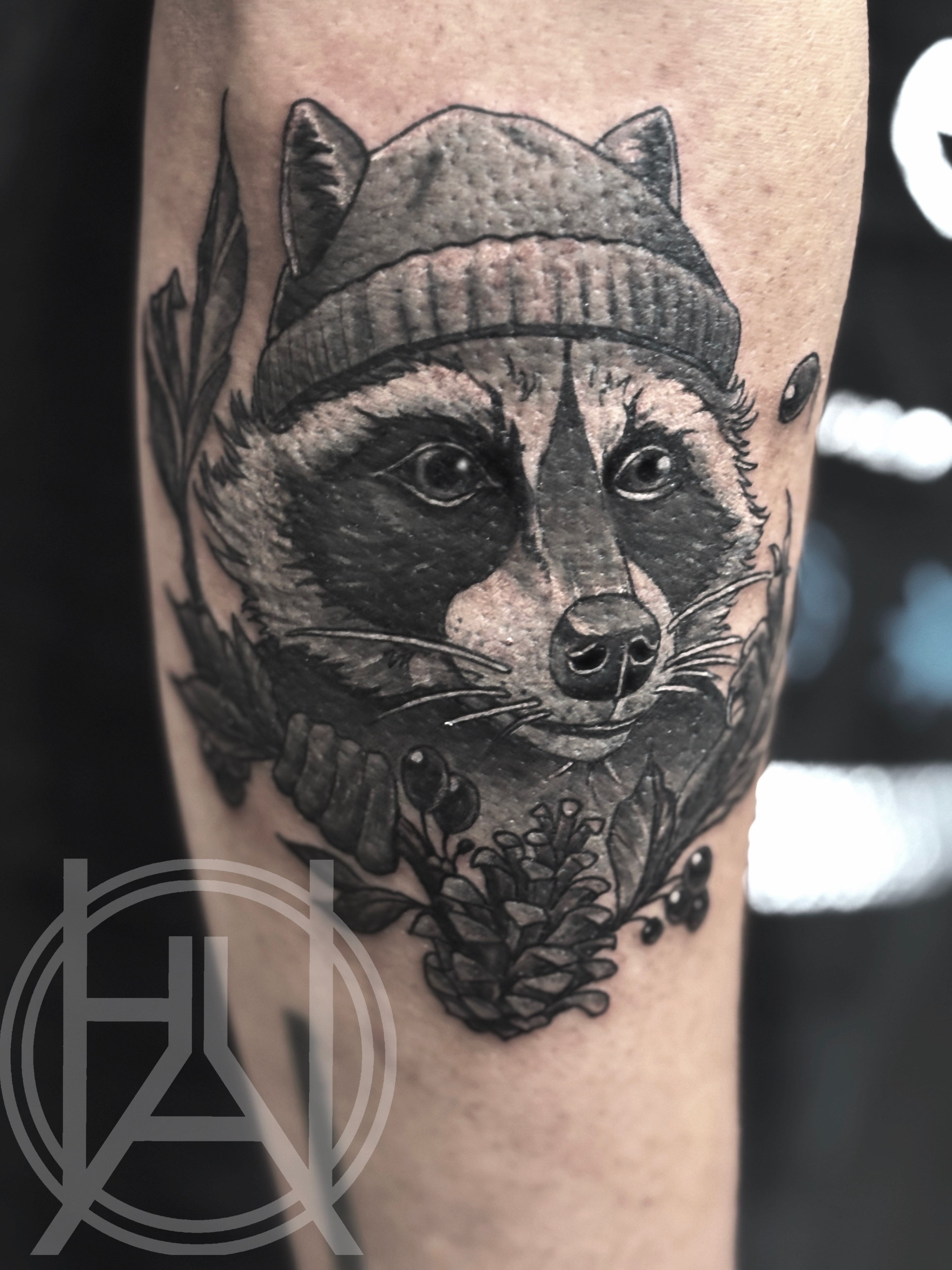 Raccoon wearing a beanie with floral elements — black and grey realism