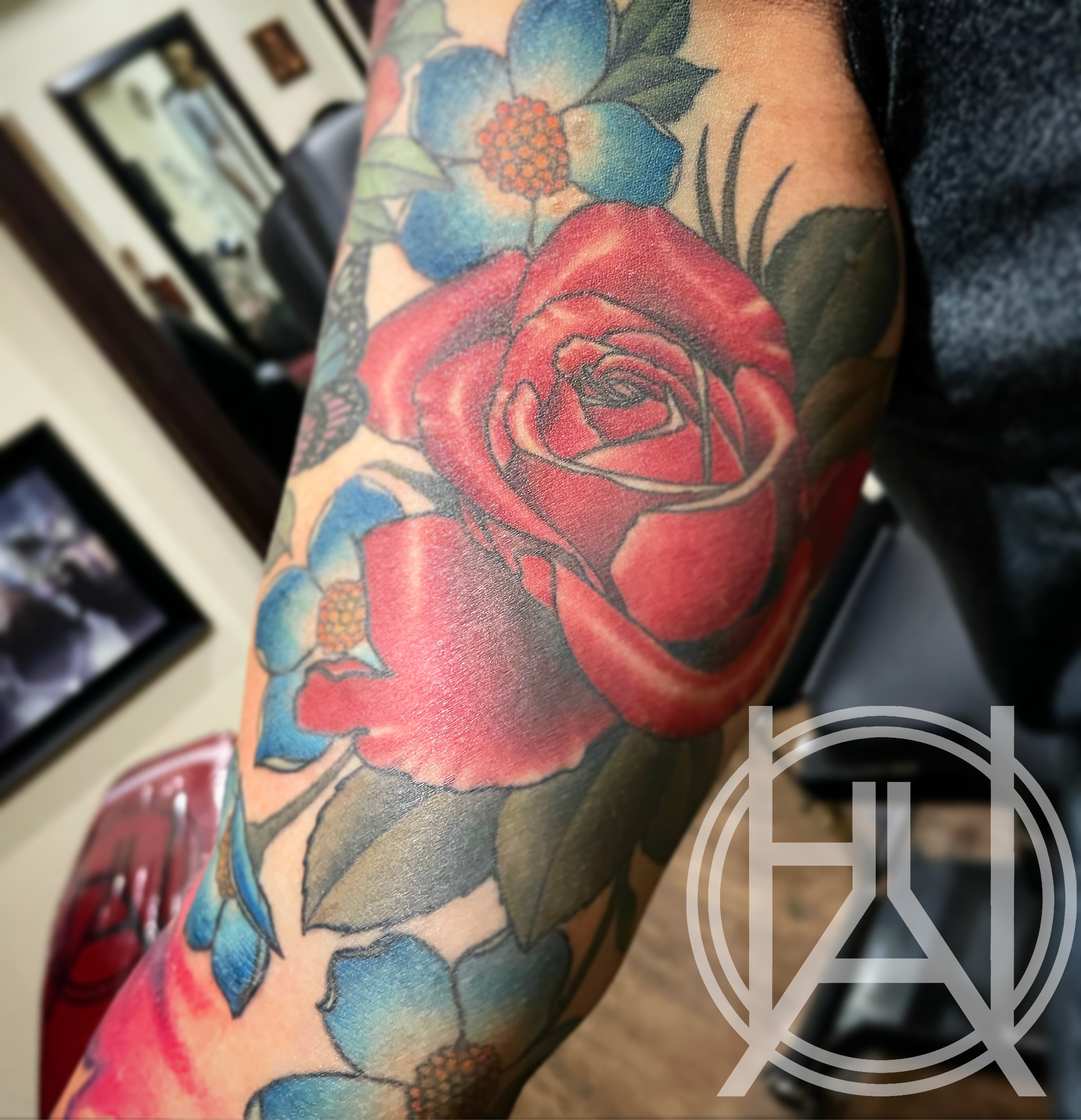 Red rose with blue wildflowers — color sleeve forearm