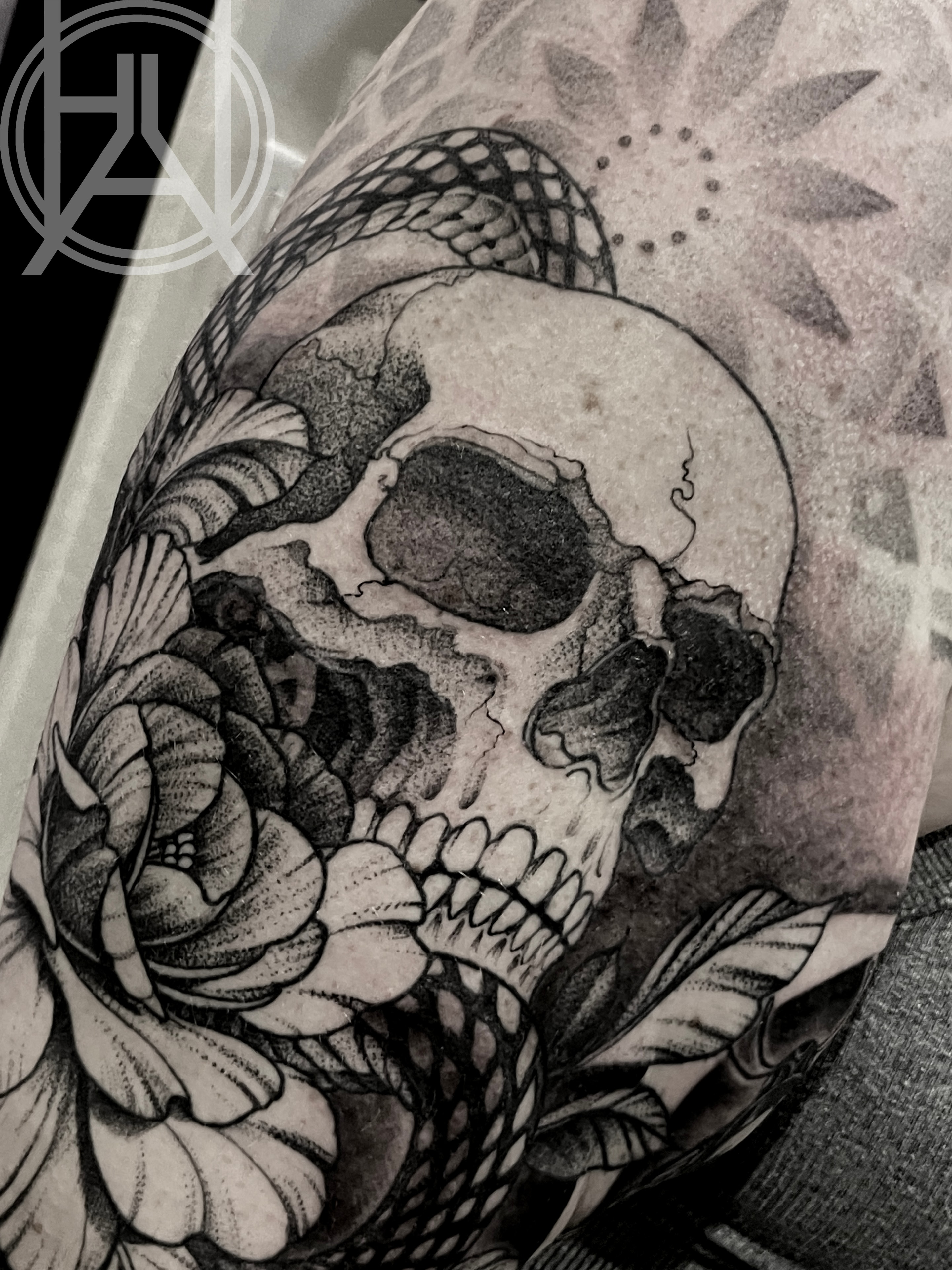 Skull with rose and snake — dot work upper arm