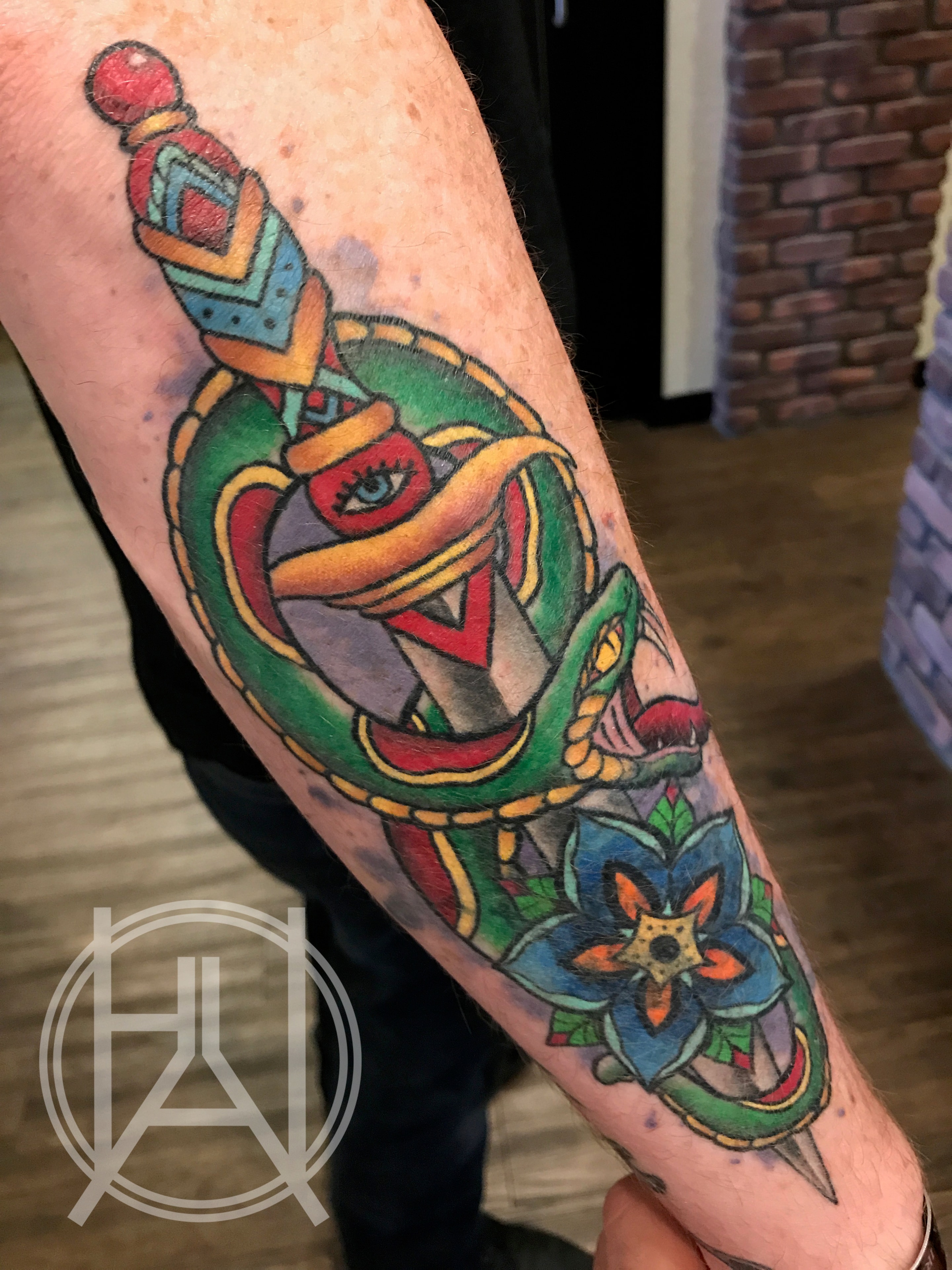 Bold traditional snake and dagger with mandala flower — color cover-up forearm