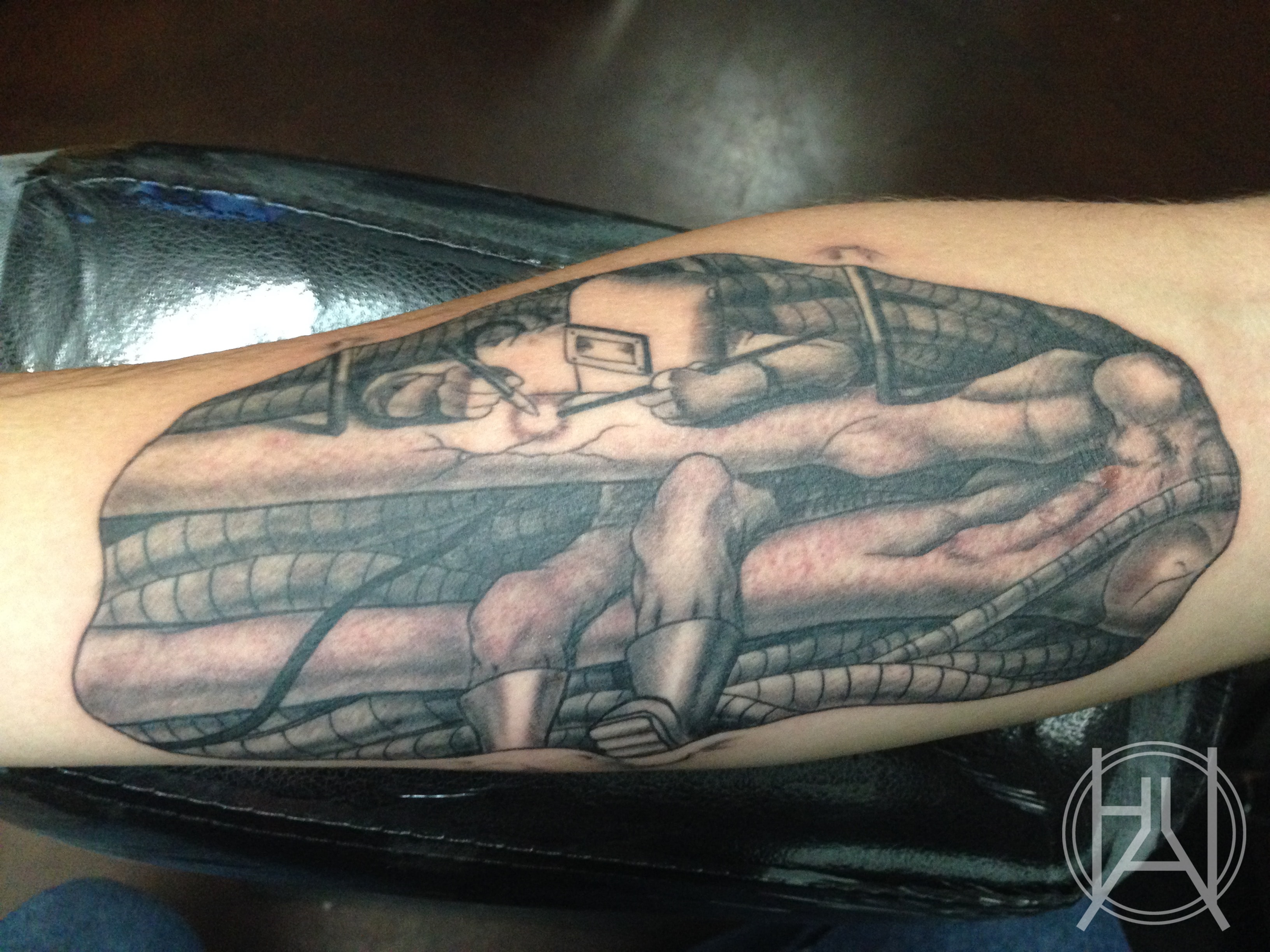 Welder scene portrait — black and grey realism forearm
