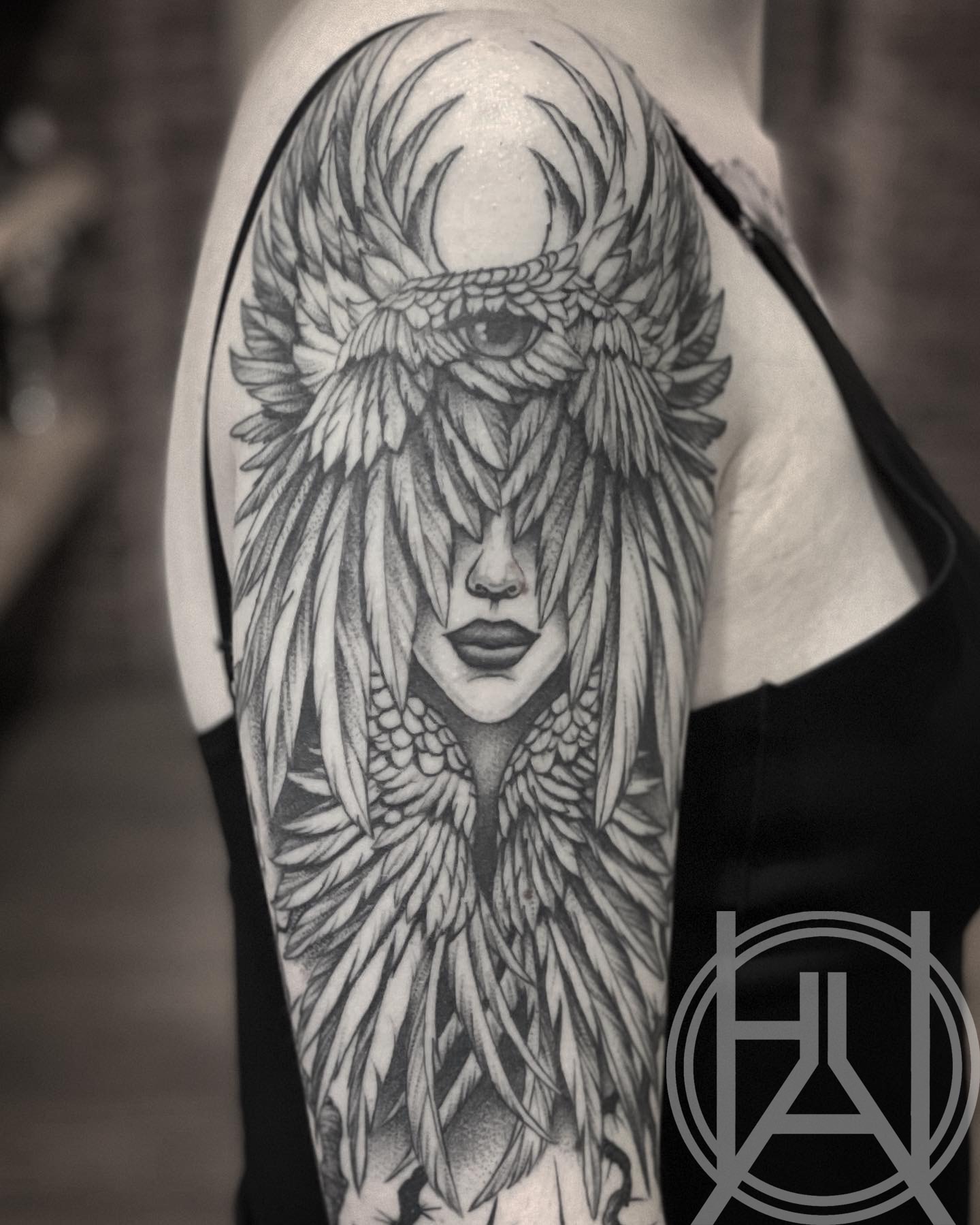 Winged goddess upper arm — dot work black and grey